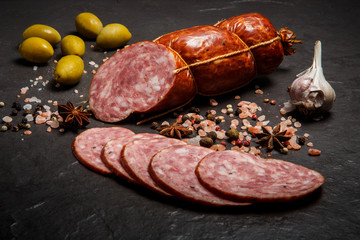 appetizing salami smoked sausage with garlic and green olives