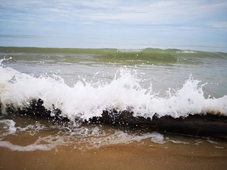 Beautiful splashing swash silky smooth water on the beach during sunny day.
