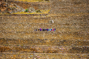 Tourists on the stony walls of Ollantaytambo bastille