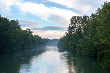 River called Adda in the north of Italy between two woods
