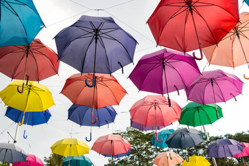 Colorful umbrellas hanging on the rope.