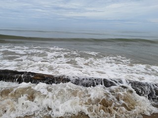 Beautiful splashing swash silky smooth water on the beach during sunny day.