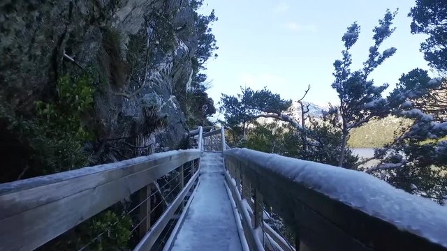 Slow Motion: Walking down a snow and ice covered pathway