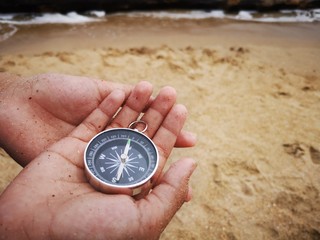 Holding a compass is an instrument used for navigation and orientation that shows direction...