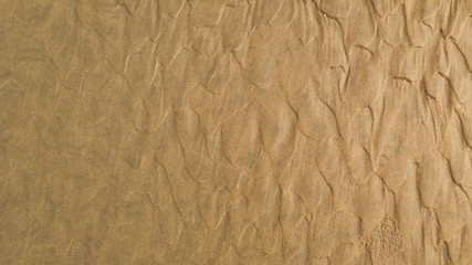 Sandy beach background with natural patterns and lines