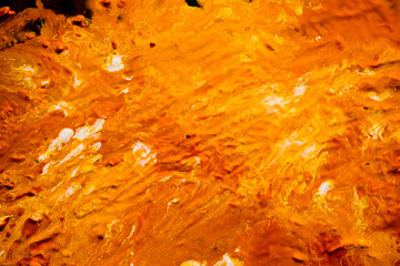 Abstract orange paint background. Swirls lines fluid mix blend surface texture. Liquid current flowing. Color gradient effect.