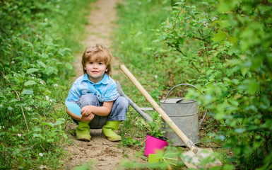 small kid gardener planting a flower. earth day. Eco life. summer activity. happy child farmer use garden shovel, spring. human and nature. farming and agriculture cultivation. Pleasant spring day