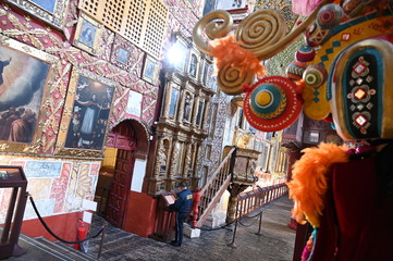Security guard marvels at ornate decor of Santa Clara church (constructed in 1647), Bogota, Colombia