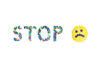 The word "STOP" written by bootle cap.