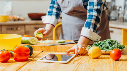 Food recipe. Electronic cookery book. Healthy diet. Croped shot of woman using modern technology to...