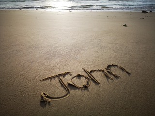 Obraz premium An English name John written on the beach.