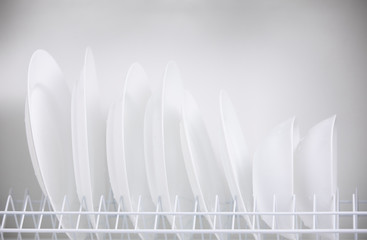 Row of clean white plates in the closet
