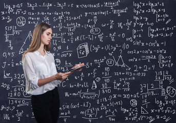 Beautiful woman thinking how to solve a math problem