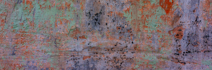 wall covered with old crumbling cement multi-colored plaster.