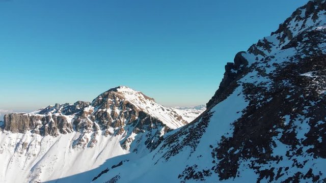 Aerial drone shot of a rocky mountain with snow in the Laograi ridge, Trentino, Italy