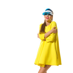 Smiling Woman In Yellow Mini Dress And Sun Visor Is Looking Away