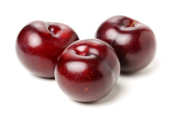 Plums on white background