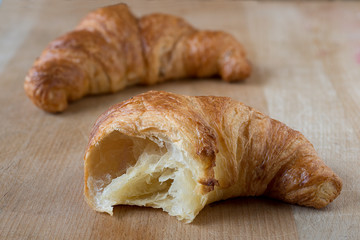 Two croissant on a wooden board