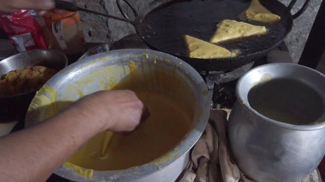 Close-up of popular snack of bread pakora stuffed with spiced mashed potatoes. a favorite breakfast and tea or chai time snack in Indian subcontinent. slow motion Handheld stabilized gimbal 4k