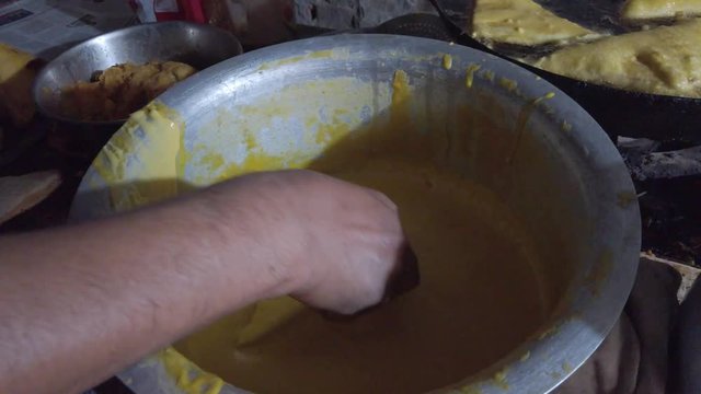 Close-up of popular snack of bread pakora stuffed with spiced mashed potatoes. a favorite breakfast and tea or chai time snack in Indian subcontinent. slow motion Handheld stabilized gimbal 4k