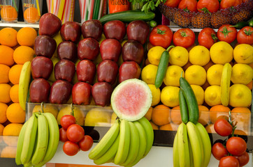 Exotic fruits on the counter (orange, coconut, watermelon, banana, apple, pineapple)
