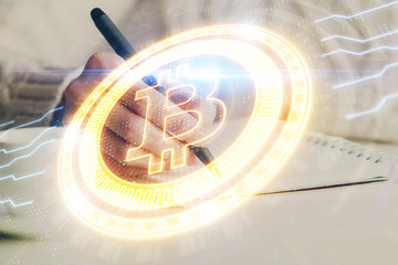 Cryptocurrency hologram over hands taking notes background. Concept of blockchain. Multi exposure
