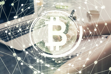 Cryptocurrency hologram over hands taking notes background. Concept of blockchain. Multi exposure