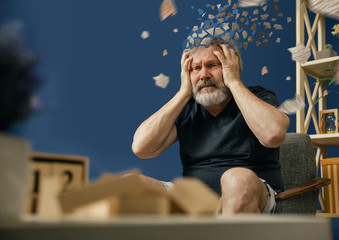 Drown image of losing of mind. Old bearded man with alzheimer desease sitting and suffering from...