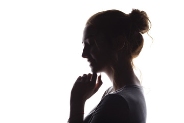 silhouette of sincere tender girl, face profile a young happy woman on a white isolated background,...