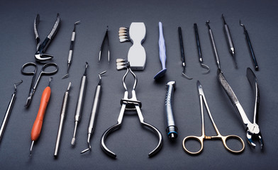Composition of different dental equipment on gray background
