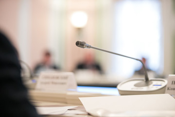 Press conference. Public speaker giving talk to Television camera. News conference. An event with a...