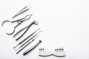 Different shiny metal medical tools on white background