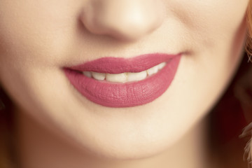 Fototapeta premium beautiful lips with matte lipstick,parts of the body, cosmetics concept