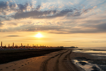Sunset over sea with oncoming waves