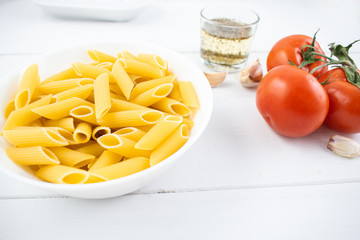 various types of pasta on a white wooden table. Italian cuisine concept, food ingredients. Close up view