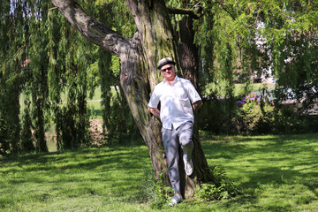 Man With Hat, Sunglasses And Tattoss In The Park