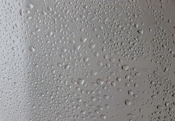 Water drops on a window glass after the rain. The  sun on background.