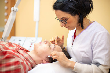 Beautician with a woman for a face treatment