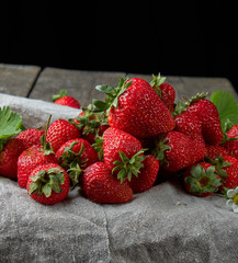  fresh ripe red strawberries on a  wooden table