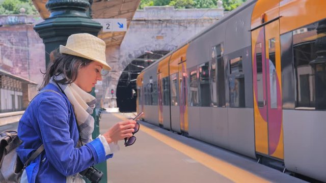 Woman tourist using smartphone in Sao Bento Railway station