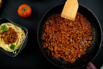 Spaghetti bolognese on a plate on wooden dark background. Italian cuisine concept, food...