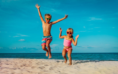 little boy and girl dance at beach, kids enjoy vacation at sea