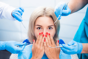 Scared blond girl in dentistry close her mouth