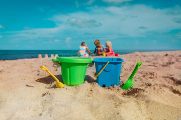 toys and kids play with sand on beach