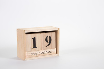 Wooden calendar September 19 on a white background