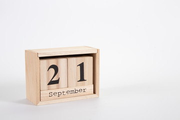 Wooden calendar September 21 on a white background