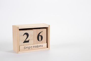 Wooden calendar September 26 on a white background