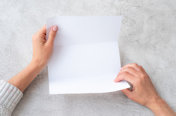 Girl's hands holding white molded sheet of paper