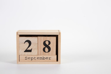 Wooden calendar September 28 on a white background