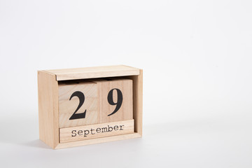 Wooden calendar September 29 on a white background